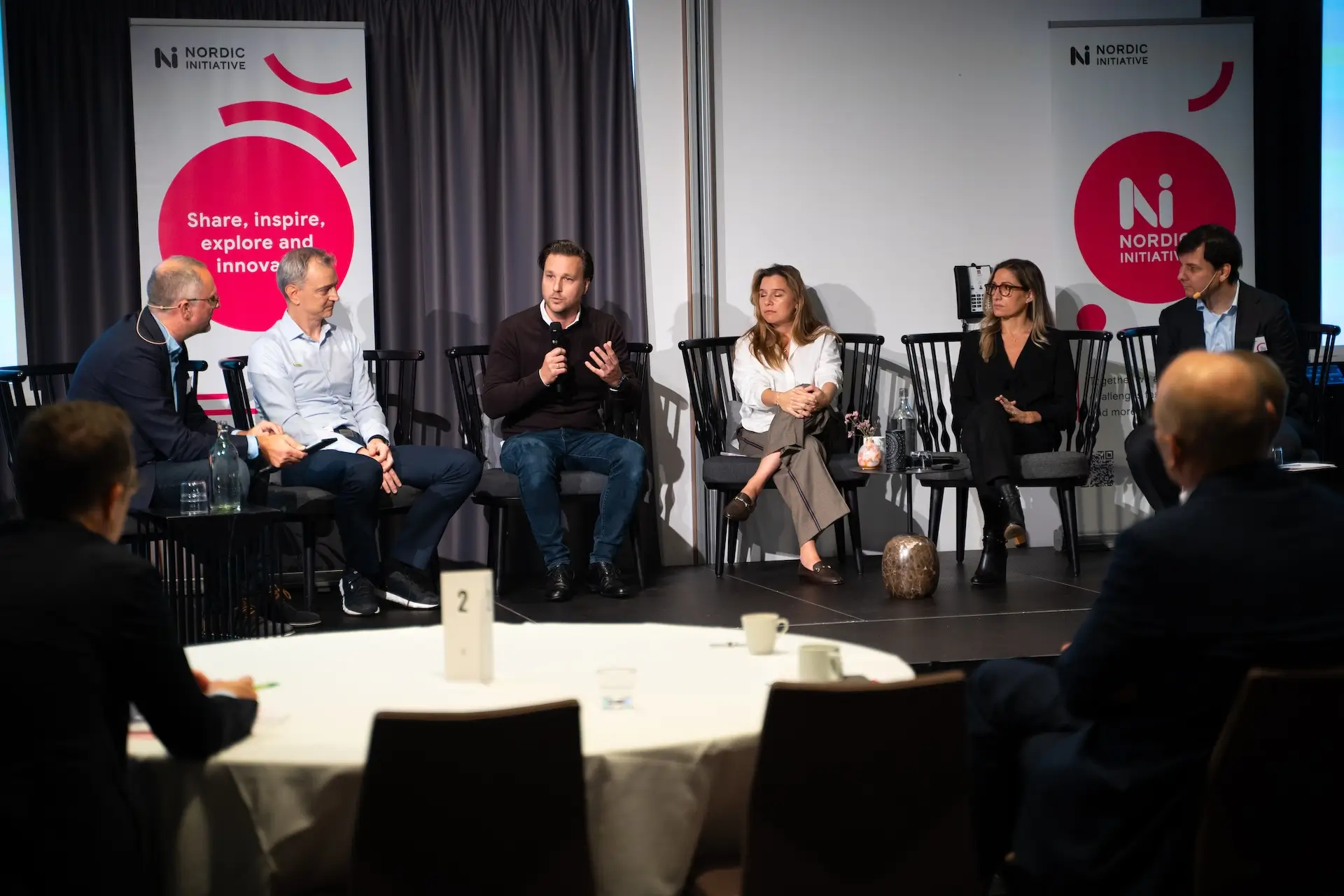 Panel discussion on stage at a Nordic Initiative gathering